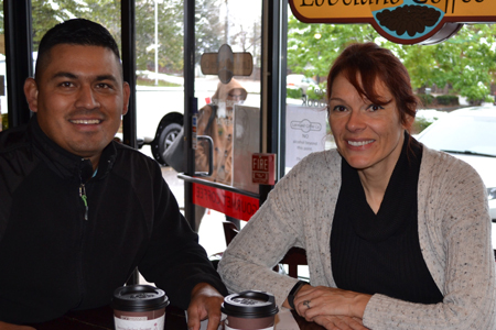 Two people sitting together at a coffee shop